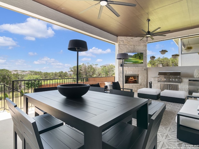 25022 Dulzura, San Antonio, TX 78261 - view of patio with exterior kitchen, ceiling fan, outdoor dining area, and an outdoor living space with a fireplace