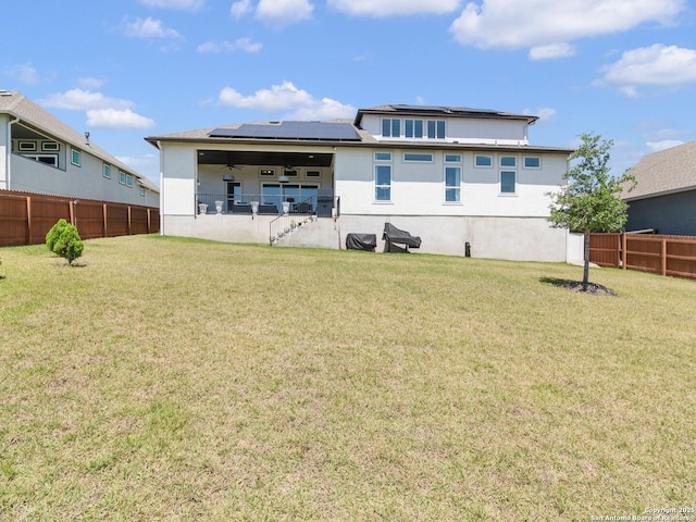 25022 Dulzura, San Antonio, TX 78261 - back of property featuring stucco siding, ceiling fan, a fenced backyard, and roof mounted solar panels