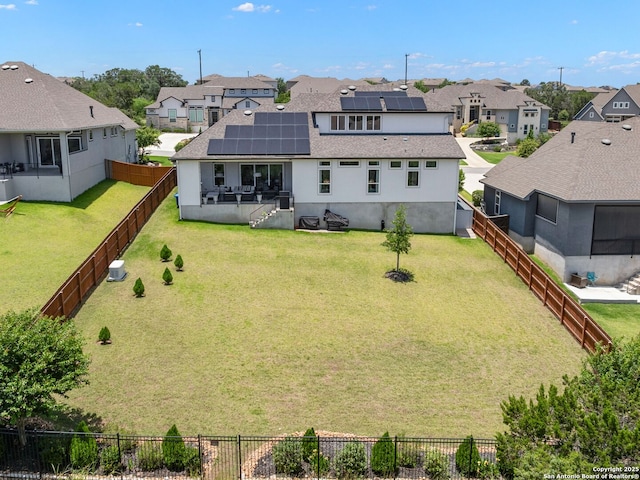 25022 Dulzura, San Antonio, TX 78261 - rear view of property featuring a residential view, roof with shingles, solar panels, and a fenced backyard