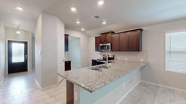 2076 Meadow Pipit, New Braunfels, TX 78130 - kitchen with stainless steel appliances, decorative backsplash, a peninsula, recessed lighting, and light stone countertops
