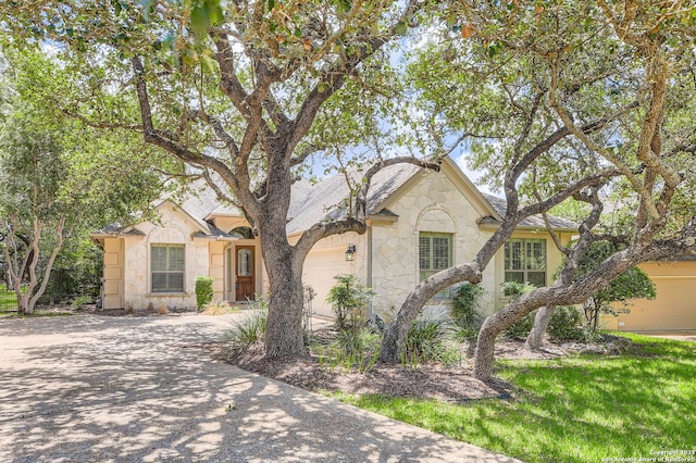 34 Roseheart, San Antonio, TX 78259 - view of front of house featuring stone siding, a garage, and concrete driveway