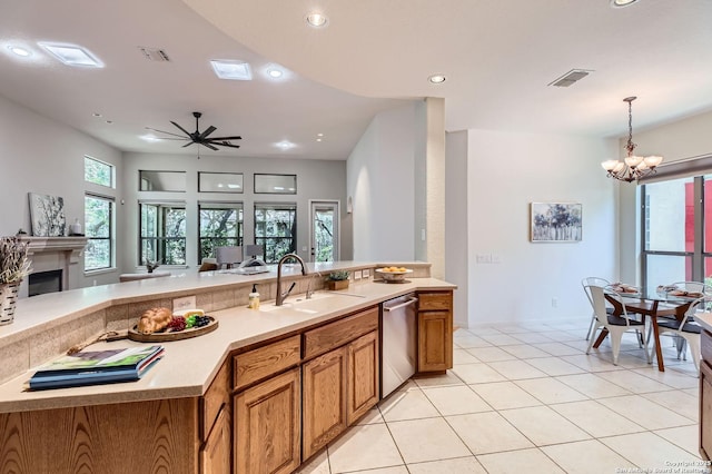 34 Roseheart, San Antonio, TX 78259 - kitchen featuring dishwasher, brown cabinets, recessed lighting, light countertops, and a chandelier