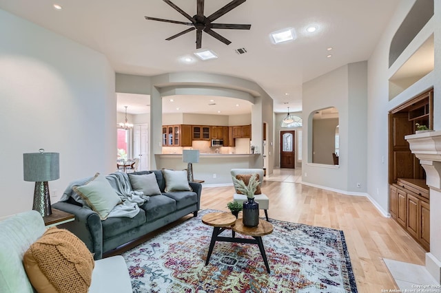 34 Roseheart, San Antonio, TX 78259 - living room featuring arched walkways, a ceiling fan, light wood-style flooring, recessed lighting, and a chandelier