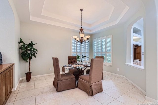 34 Roseheart, San Antonio, TX 78259 - dining room with a tray ceiling, a chandelier, arched walkways, and light tile patterned flooring
