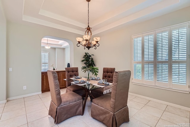 34 Roseheart, San Antonio, TX 78259 - dining space featuring a tray ceiling, arched walkways, a chandelier, and light tile patterned flooring
