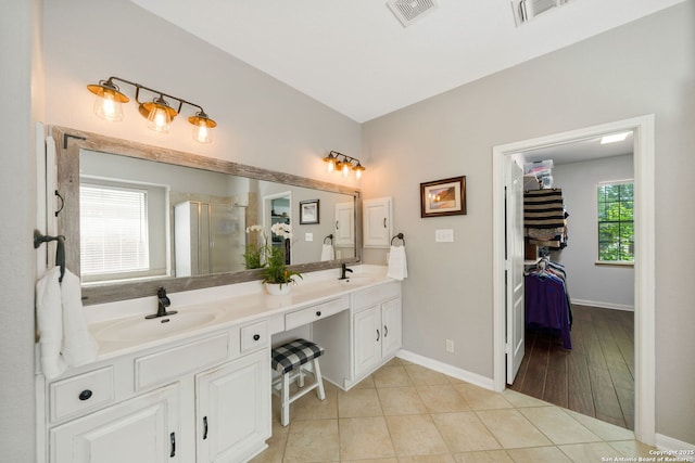 3118 Limestone, San Antonio, TX 78253 - bathroom with double vanity, a stall shower, a spacious closet, and tile patterned flooring