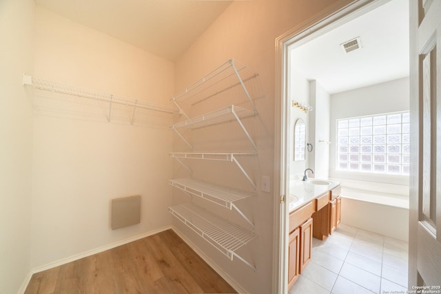 16914 Redhorse Pass, San Antonio, TX 78247 - walk in closet with a sink and light wood-style flooring