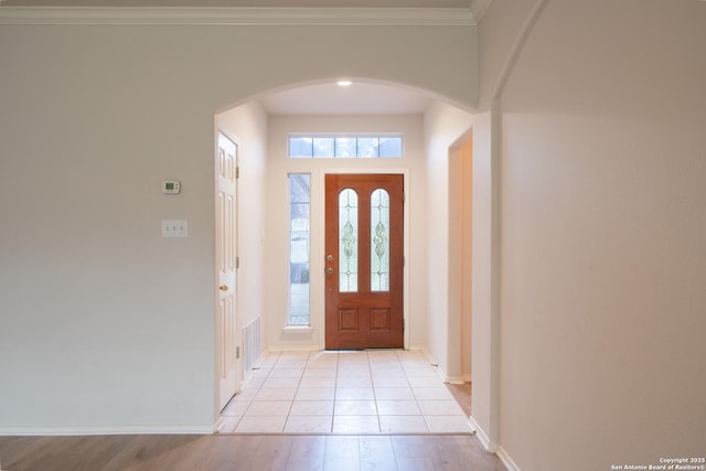 16914 Redhorse Pass, San Antonio, TX 78247 - entrance foyer with arched walkways, light wood-type flooring, and crown molding