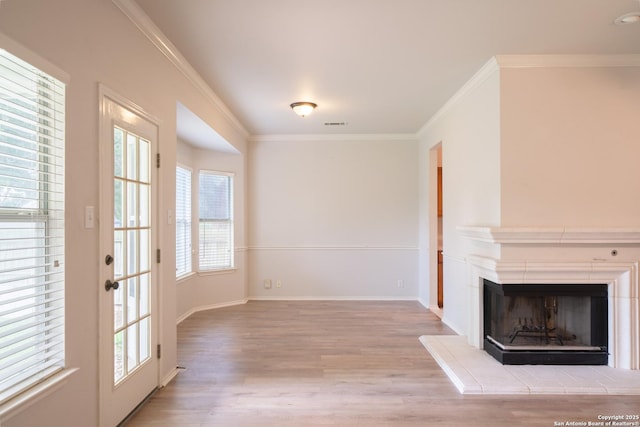 16914 Redhorse Pass, San Antonio, TX 78247 - unfurnished living room with wood finished floors, healthy amount of natural light, ornamental molding, and a fireplace with raised hearth