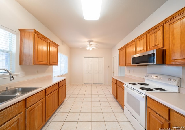 16914 Redhorse Pass, San Antonio, TX 78247 - kitchen with white range with electric stovetop, stainless steel microwave, a ceiling fan, and light countertops