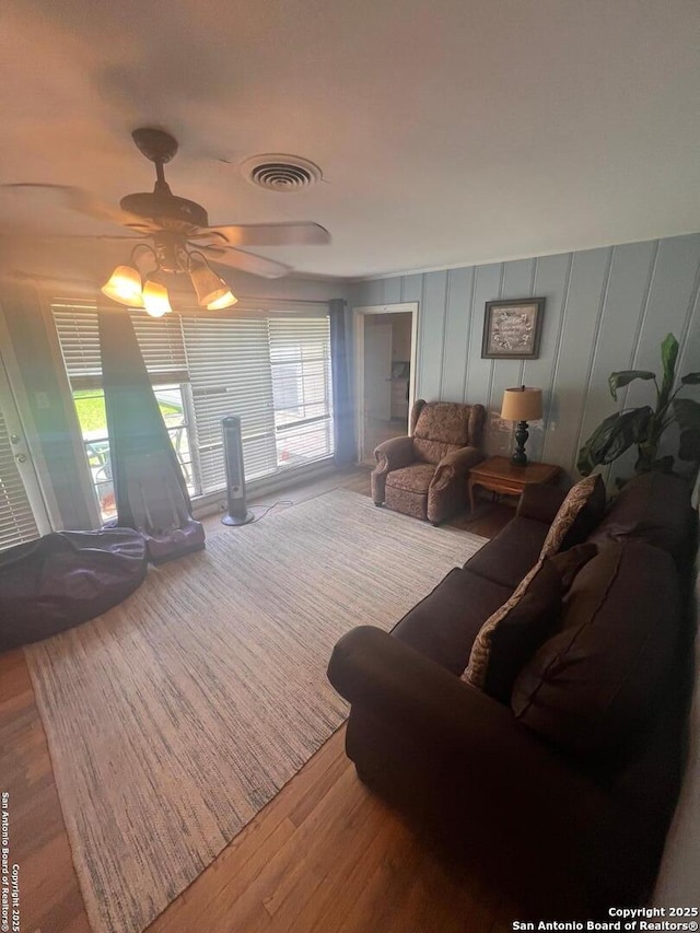 4849 Briarbend, Houston, TX 77035 - living room with wood finished floors, ceiling fan, and a decorative wall