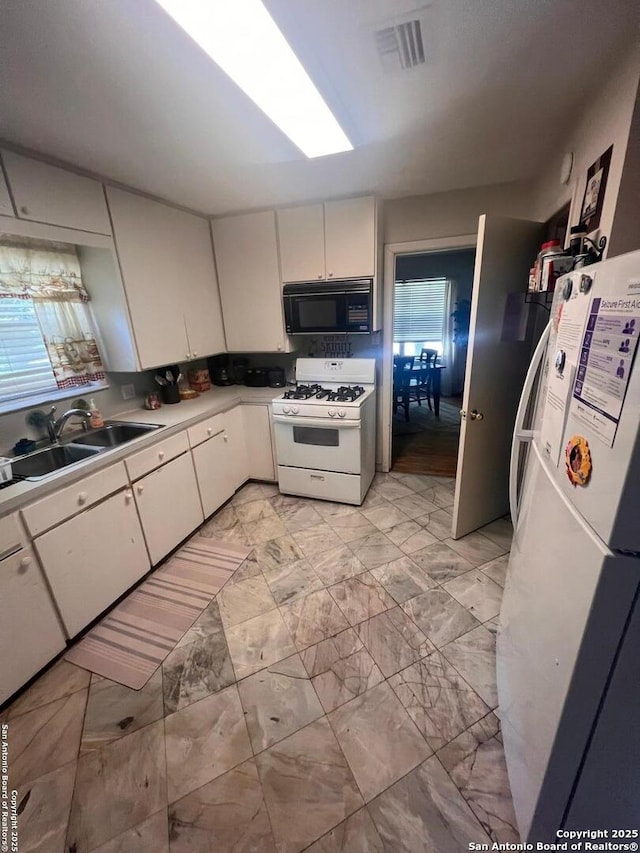 4849 Briarbend, Houston, TX 77035 - kitchen with white appliances, light countertops, light marble finish floors, and white cabinets