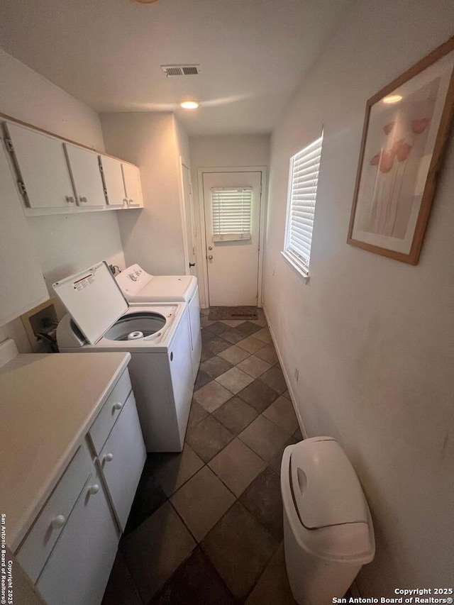 4849 Briarbend, Houston, TX 77035 - laundry area with cabinet space, washer and dryer, and dark tile patterned flooring