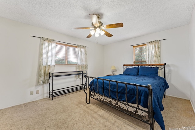 33171 Blanco Rd, Bulverde, TX 78163 - bedroom featuring multiple windows, carpet flooring, a textured ceiling, and a ceiling fan