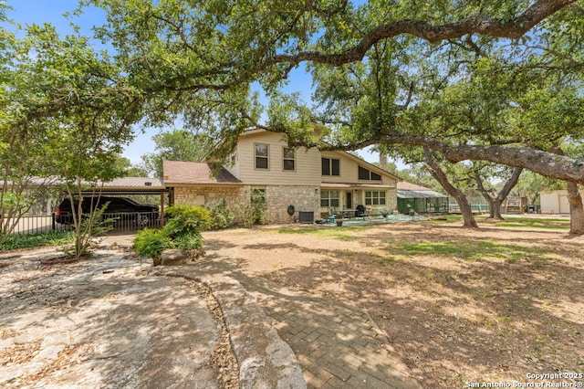 33171 Blanco Rd, Bulverde, TX 78163 - rear view of property with stone siding and a patio area