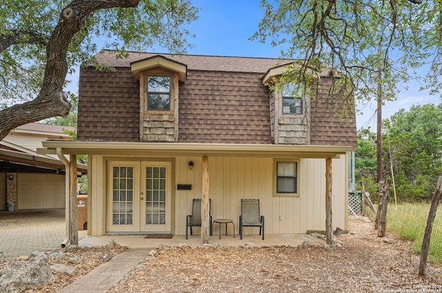 33171 Blanco Rd, Bulverde, TX 78163 - view of front of house with french doors, roof with shingles, mansard roof, and driveway