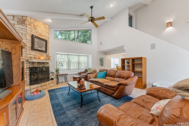 33171 Blanco Rd, Bulverde, TX 78163 - living room with light tile patterned flooring, a stone fireplace, ceiling fan, high vaulted ceiling, and beamed ceiling