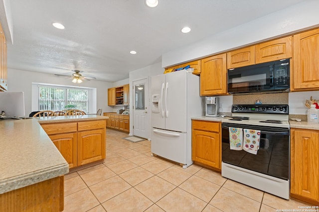 33171 Blanco Rd, Bulverde, TX 78163 - kitchen with electric stove, black microwave, white fridge with ice dispenser, ceiling fan, and light countertops
