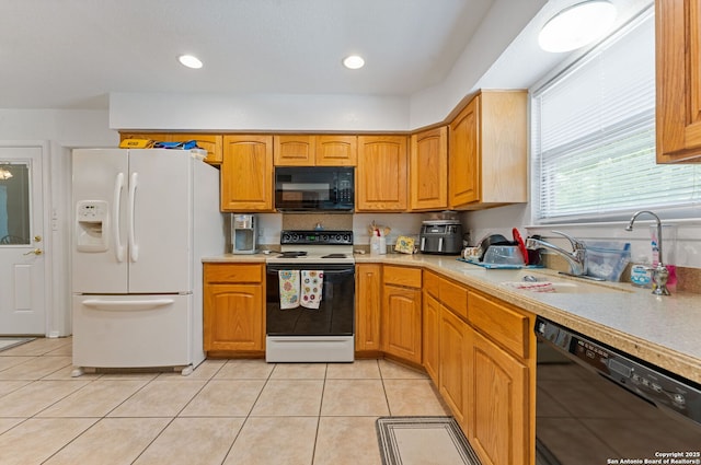 33171 Blanco Rd, Bulverde, TX 78163 - kitchen with black appliances, light countertops, light tile patterned floors, brown cabinets, and recessed lighting