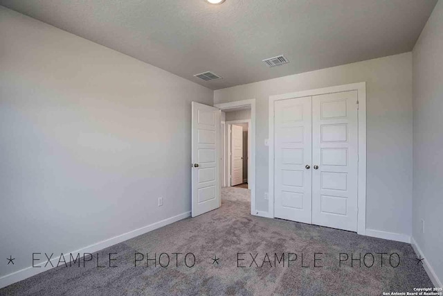 9974 Forestier Grn, San Antonio, TX 78221 - unfurnished bedroom featuring carpet flooring and a closet