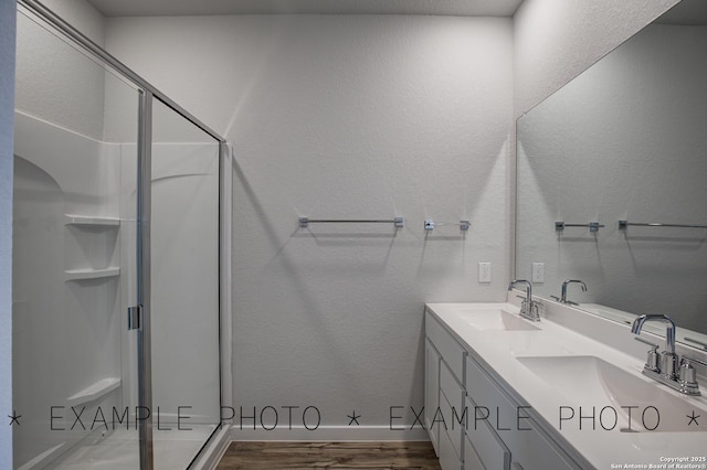4311 Clarisse St, New Braunfels, TX 78130 - bathroom featuring a stall shower, wood finished floors, double vanity, and a textured wall