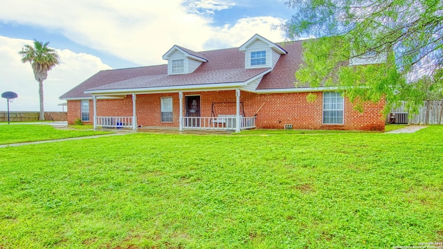 103 Weese, Pleasanton, TX 78064 - new england style home with brick siding, a shingled roof, and covered porch