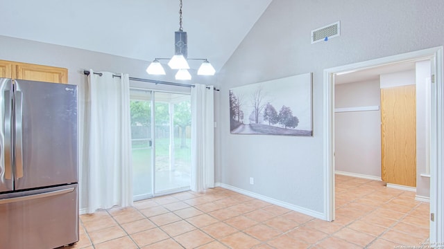 103 Weese, Pleasanton, TX 78064 - unfurnished dining area with light tile patterned floors, high vaulted ceiling, and a chandelier