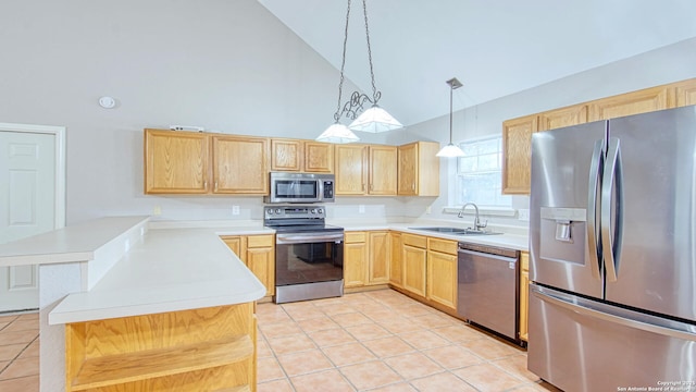 103 Weese, Pleasanton, TX 78064 - kitchen with stainless steel appliances, high vaulted ceiling, light brown cabinets, light tile patterned floors, and a peninsula