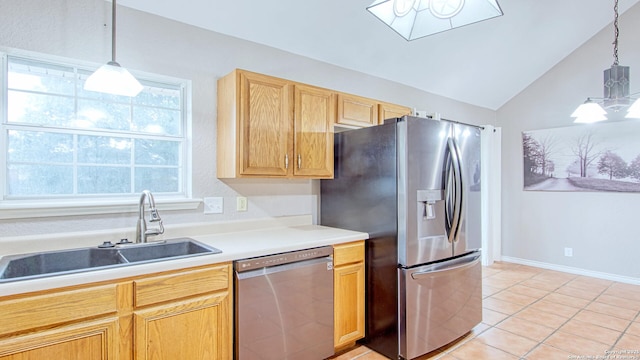 103 Weese, Pleasanton, TX 78064 - kitchen featuring appliances with stainless steel finishes, vaulted ceiling, light tile patterned flooring, pendant lighting, and light countertops