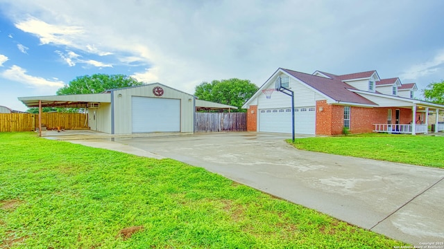 103 Weese, Pleasanton, TX 78064 - garage featuring a garage, concrete driveway, and a porch