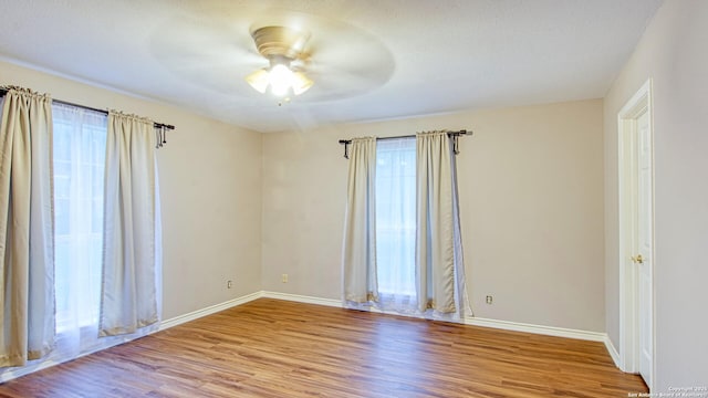 103 Weese, Pleasanton, TX 78064 - spare room with wood finished floors, a ceiling fan, and a textured ceiling