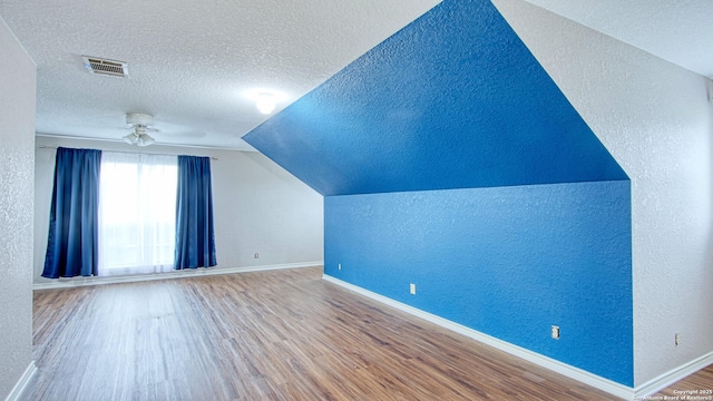 103 Weese, Pleasanton, TX 78064 - bonus room featuring a textured ceiling, a textured wall, wood finished floors, vaulted ceiling, and a ceiling fan