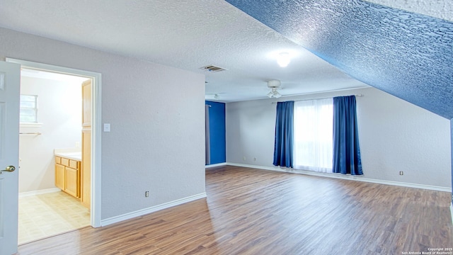 103 Weese, Pleasanton, TX 78064 - spare room featuring wood finished floors, a textured ceiling, and a textured wall