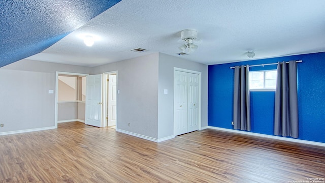 103 Weese, Pleasanton, TX 78064 - empty room with wood finished floors, a textured ceiling, and a ceiling fan