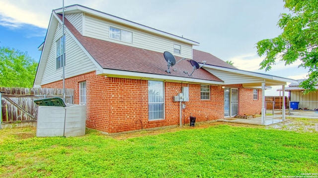 103 Weese, Pleasanton, TX 78064 - back of property featuring brick siding, a patio area, and a shingled roof