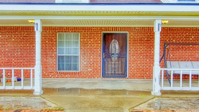 103 Weese, Pleasanton, TX 78064 - entrance to property featuring covered porch and brick siding