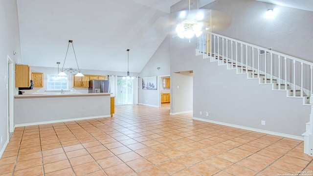 103 Weese, Pleasanton, TX 78064 - unfurnished living room with high vaulted ceiling, a ceiling fan, stairs, and light tile patterned floors
