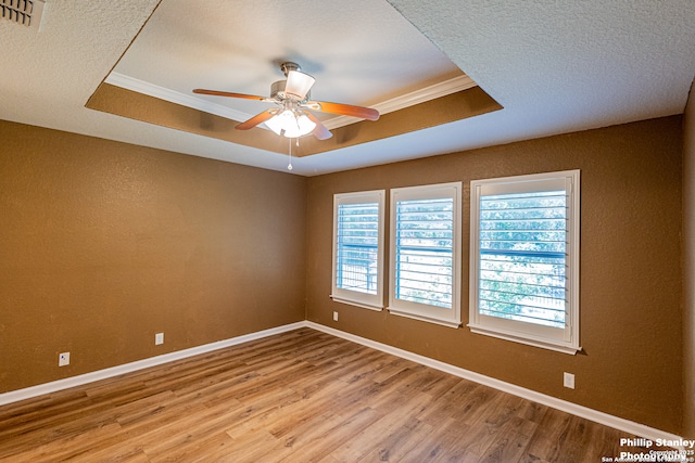 5038 Sandhill Crane, San Antonio, TX 78253 - empty room featuring a raised ceiling, light wood-type flooring, crown molding, ceiling fan, and a textured ceiling
