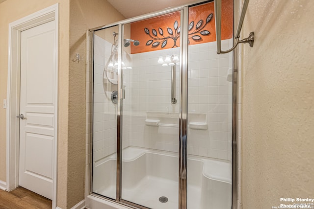 5038 Sandhill Crane, San Antonio, TX 78253 - bathroom with a textured wall, a stall shower, and wood finished floors