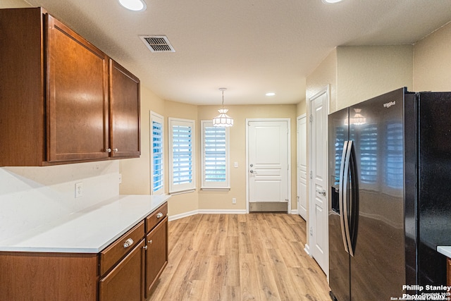 5038 Sandhill Crane, San Antonio, TX 78253 - kitchen with black fridge, light wood-style flooring, light countertops, recessed lighting, and hanging light fixtures