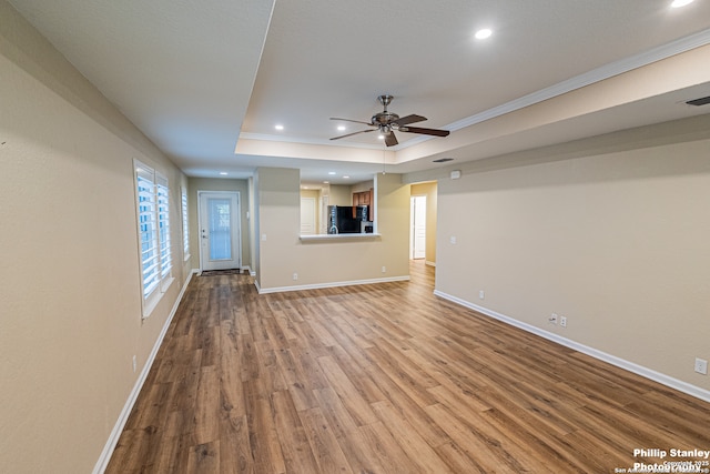 5038 Sandhill Crane, San Antonio, TX 78253 - unfurnished living room with wood finished floors, a ceiling fan, recessed lighting, ornamental molding, and a tray ceiling