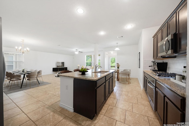 14724 Costa Leon, San Antonio, TX 78245 - kitchen with stainless steel appliances, tasteful backsplash, a center island with sink, hanging light fixtures, and recessed lighting