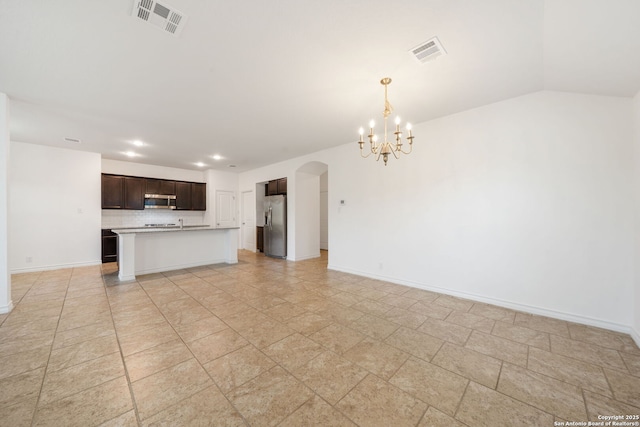 14724 Costa Leon, San Antonio, TX 78245 - unfurnished living room with a chandelier, arched walkways, recessed lighting, and lofted ceiling