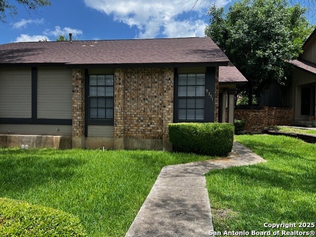 9351 Dover Rdg, San Antonio, TX 78250 - view of side of home featuring a lawn and brick siding