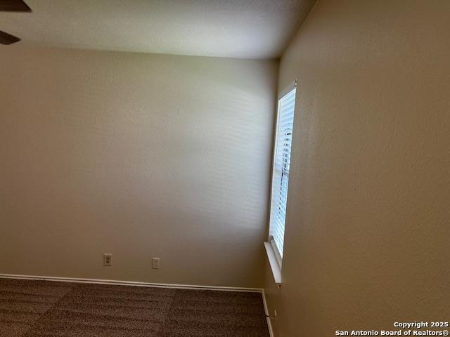 9351 Dover Rdg, San Antonio, TX 78250 - unfurnished room with carpet and a ceiling fan