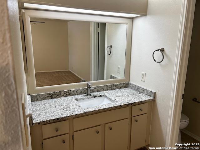9351 Dover Rdg, San Antonio, TX 78250 - bathroom featuring vanity and toilet
