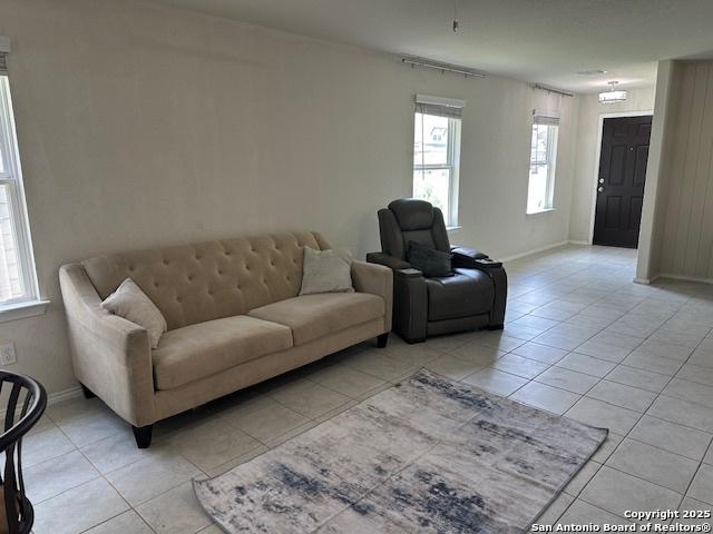 9510 Silveer Mist Way, San Antonio, TX 78254 - living area with light tile patterned floors and healthy amount of natural light