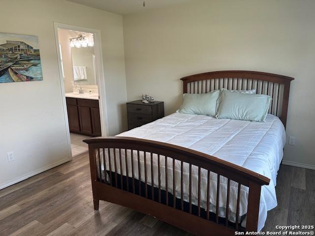 9510 Silveer Mist Way, San Antonio, TX 78254 - bedroom featuring wood finished floors and connected bathroom
