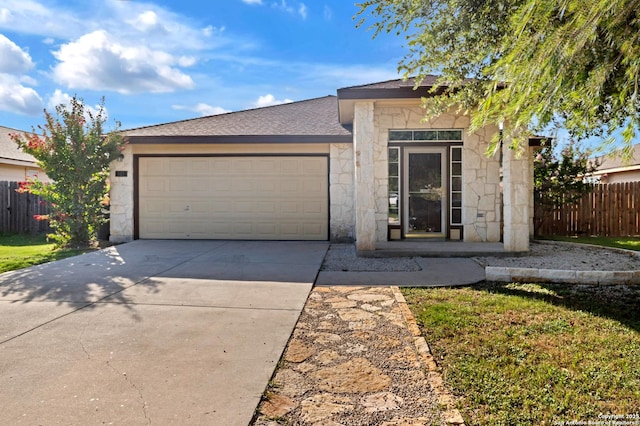 603 Starling Crk, New Braunfels, TX 78130 - view of front of home with stone siding, driveway, an attached garage, and a shingled roof