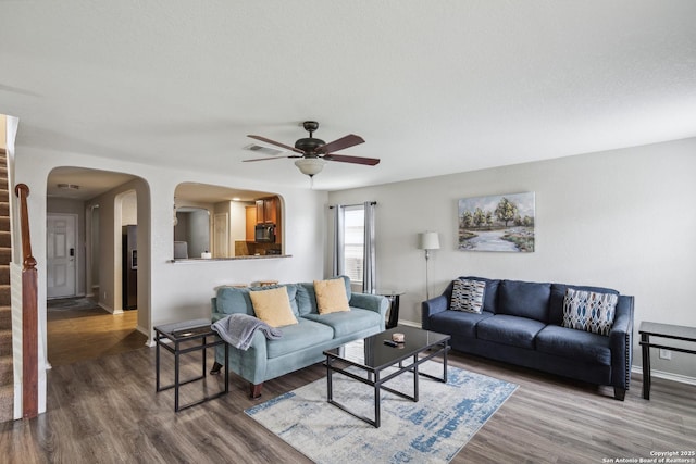 1826 Strawhouse, San Antonio, TX 78245 - living area with a ceiling fan, wood finished floors, stairs, and arched walkways
